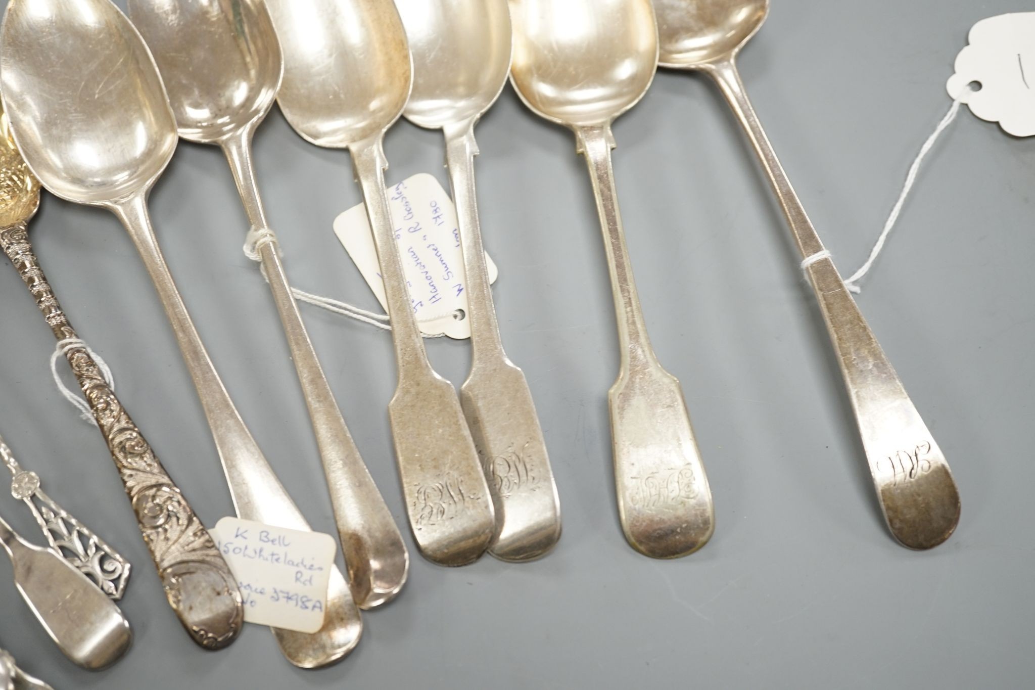 A small collection of 18th century and later silver flatware, including a table spoon by Thomas Eustace, Exeter, 1785, two 18th century silver lace back dessert spoons, an 18th century 'berry' spoon, a George III silver